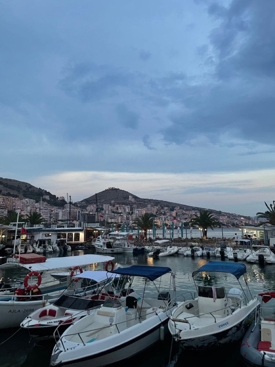 Marina with boats, yachts, and scenic cityscape in the background, emphasizing consulting and recruiting services.
