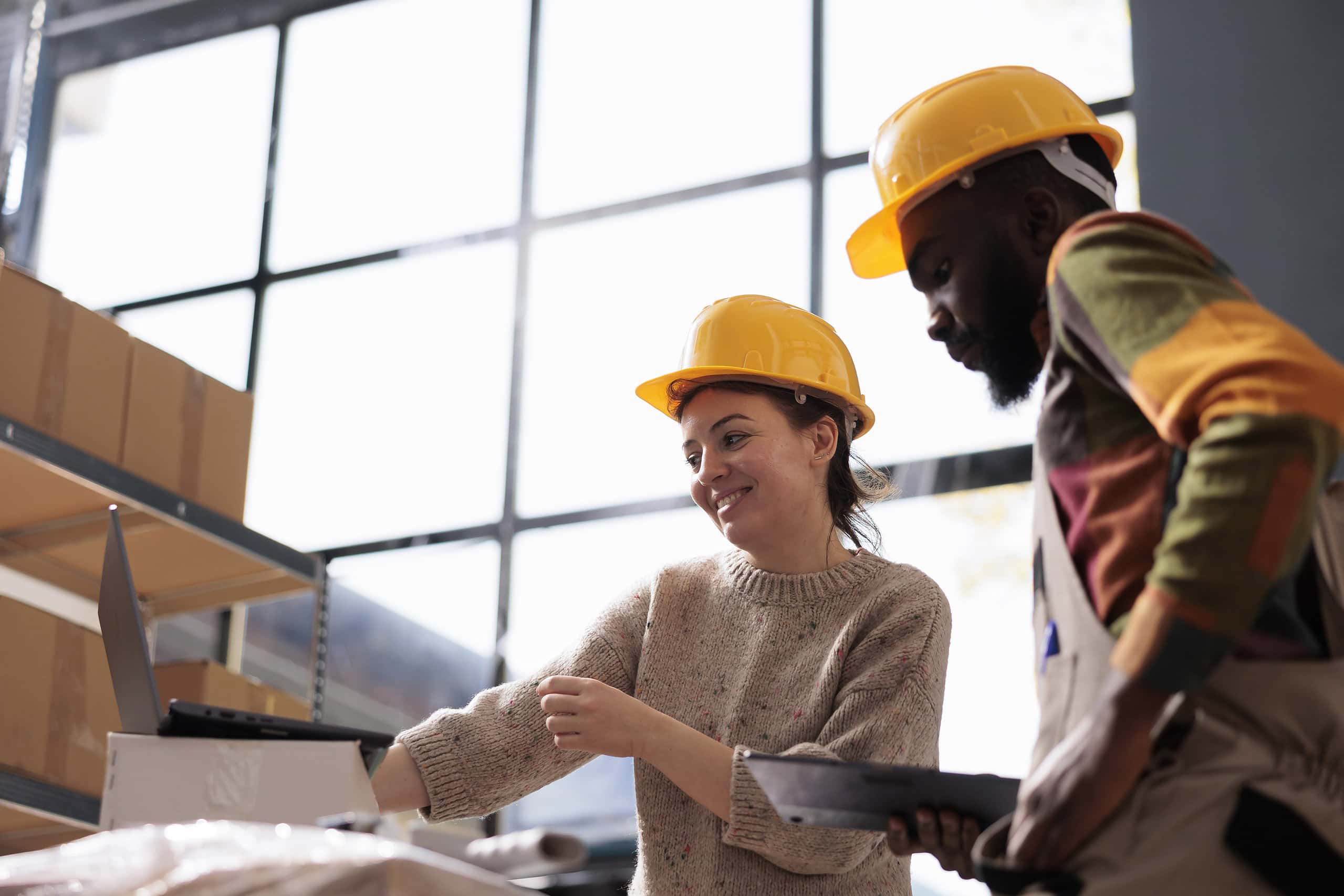 Diverse professionals collaborating in a warehouse setting.